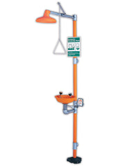 Emergency safety station with orange plastic bowl, overhead shower head, and eye wash nozzle mounted on vertical post.