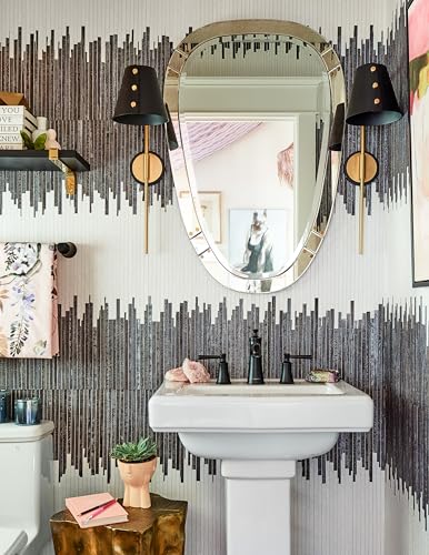 Matte black widespread bathroom faucet with two handles mounted on white pedestal sink.
