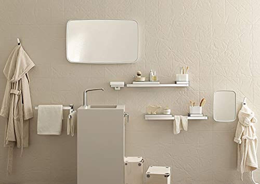 Chrome towel bar with horizontal rail design mounted on beige bathroom wall.