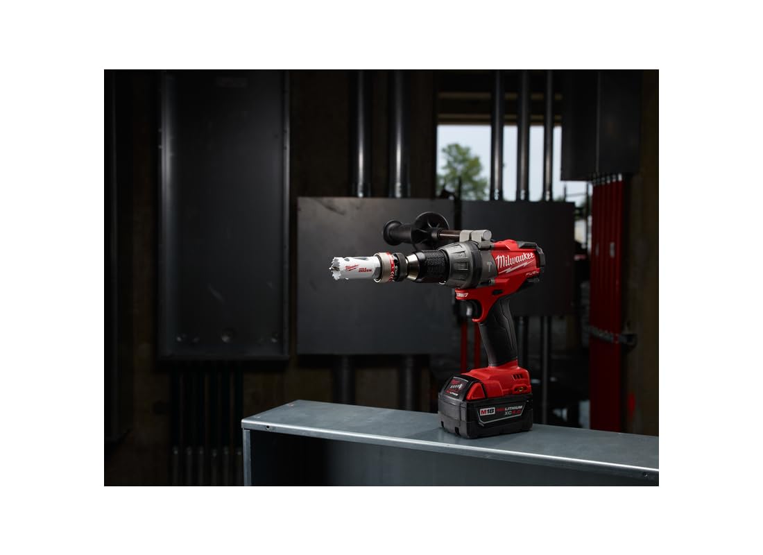 Milwaukee cordless drill with bi-metal hole saw attachment mounted on drill chuck, positioned on work table.