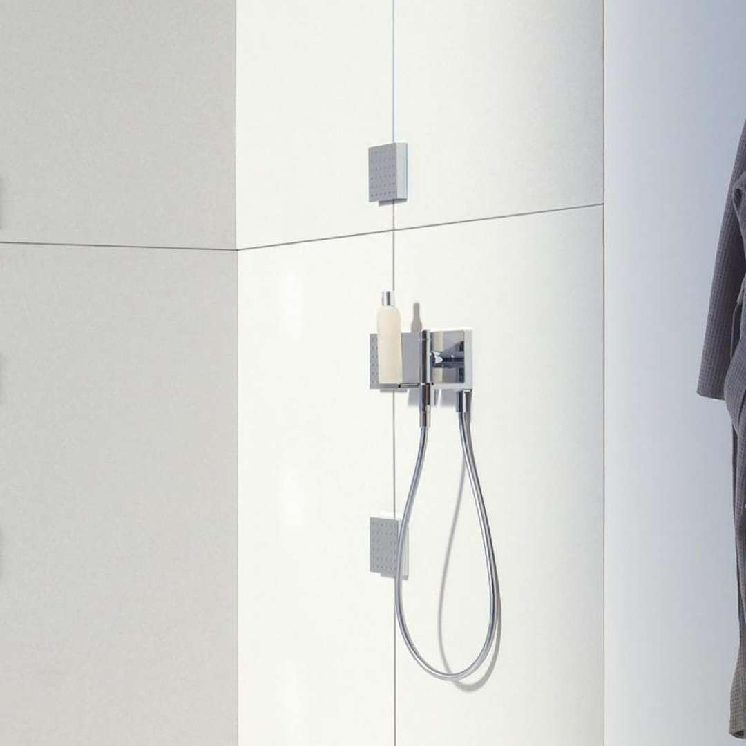 Chrome shower shelf mounted vertically on tile wall with soap bar and handheld showerhead.