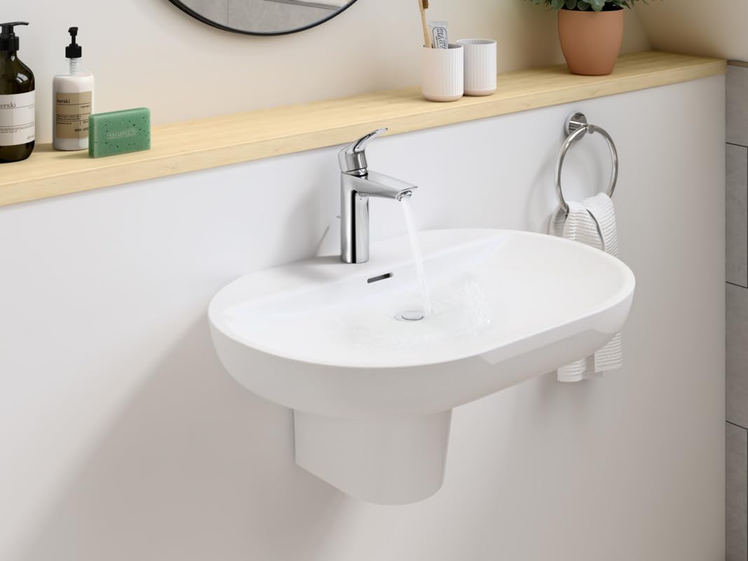 Chrome single-handle bathroom faucet with curved spout mounted on white oval sink.