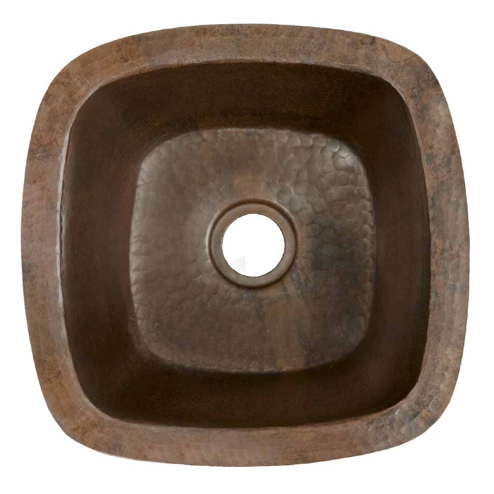 Small square hammered copper sink with rounded corners and center drain hole, viewed from above.