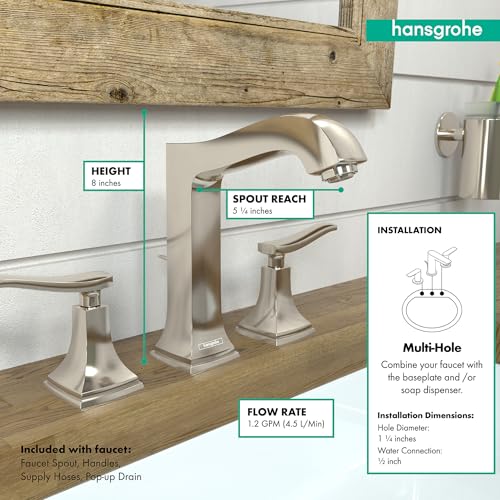 Polished nickel widespread faucet with lever handles, arched spout, and pop-up drain installed on wooden countertop.