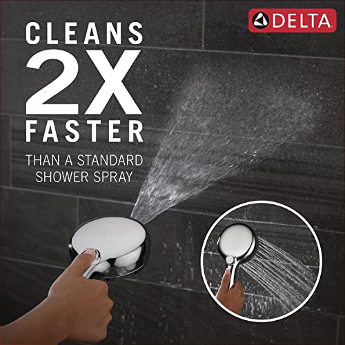 Chrome Delta hand shower with six spray settings, held in hand against dark tile background with water spray demonstration.