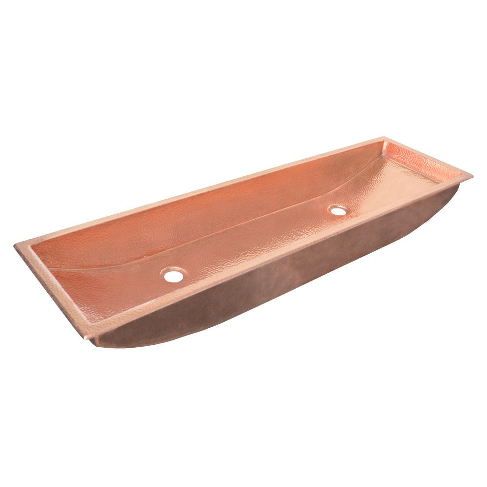 Polished copper trough sink with two faucet holes and curved interior basin.