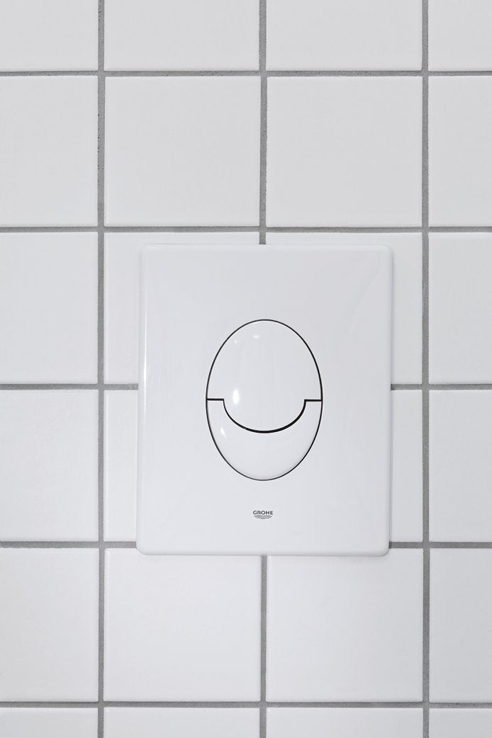 White square wall plate with oval dual-button design and Grohe branding, mounted on tiled surface.