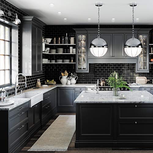 Chrome kitchen faucet with dual spray function installed at sink in modern black and white kitchen.