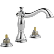 Chrome widespread bathroom faucet with curved spout and two brass valve handles with circular bases.