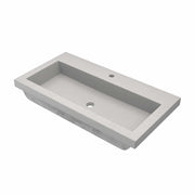 Rectangular ash-colored concrete trough sink with single drain hole and faucet mounting hole.