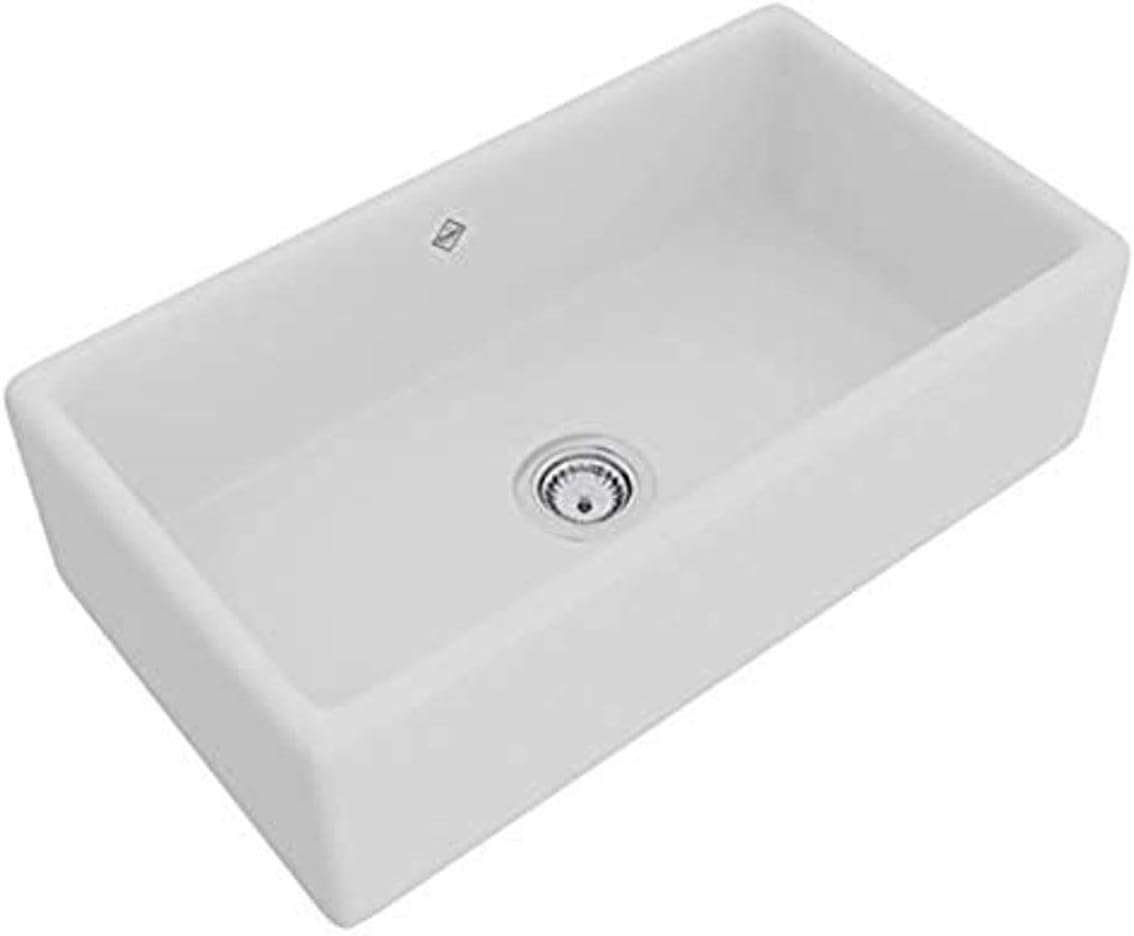 White fireclay apron front kitchen sink with single bowl and drain opening.