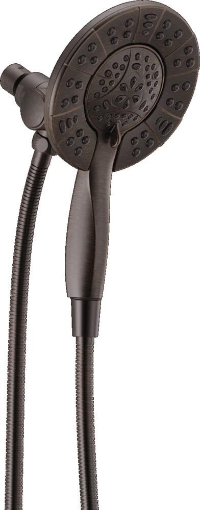 Round dark gray showerhead with spray holes and attached handheld shower with flexible hose.