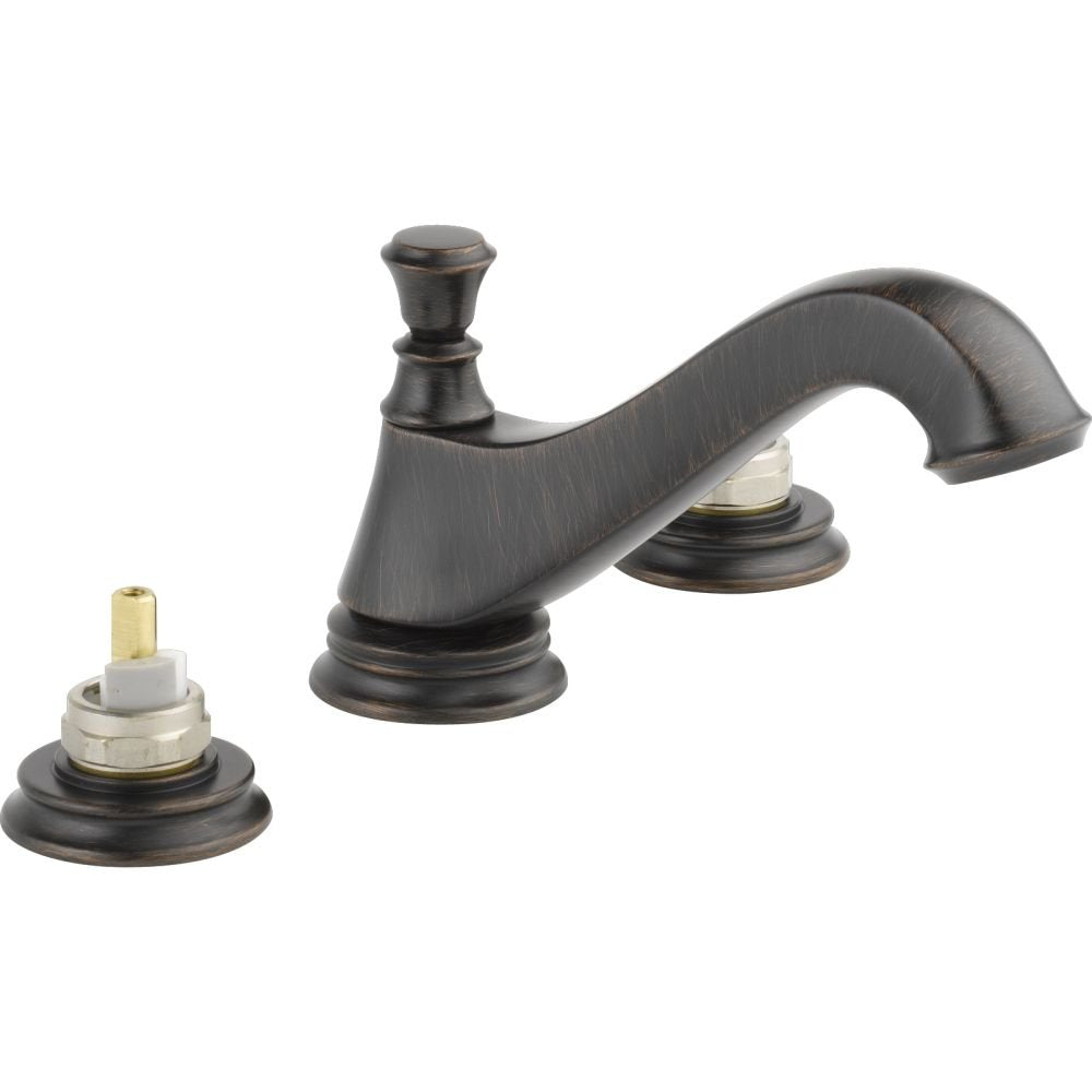 Two-handle widespread bathroom faucet with low arc spout, decorative handles, and metal drain pop-up in oil-rubbed bronze fin