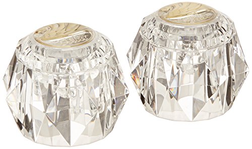 Pair of clear faceted crystal knob handles with polished brass-finish metal collars.