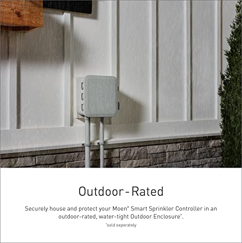 Blue Moen smart sprinkler controller mounted on exterior wall with white vertical siding and stone base trim.