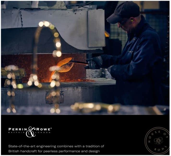 Unlacquered brass pull-down bridge kitchen faucet with U-shaped spout shown in industrial manufacturing setting.