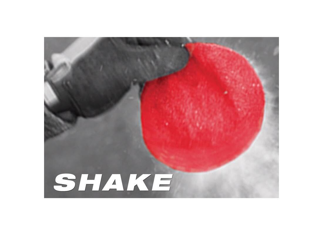 Red circular sanding sheet with textured surface held in hand, demonstrating shake-off dust removal feature.