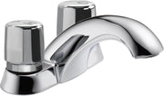Chrome two-handle metering faucet with cylindrical knob handles and curved spout for commercial use.