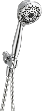 Chrome hand shower with multiple spray holes, attached to wall mount and flexible hose.