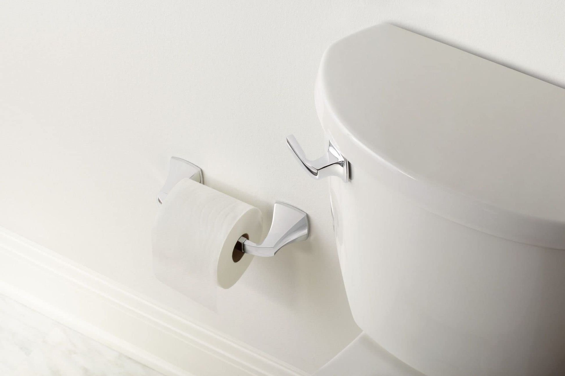 Brushed nickel toilet tank lever handle mounted on white porcelain tank.