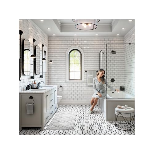 Matte black widespread faucet with two handles and pop-up drain installed on bathroom vanity.