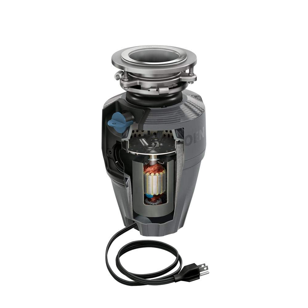 Gray Moen garbage disposal with stainless steel sink flange, internal grinding chamber visible, and attached black power cord