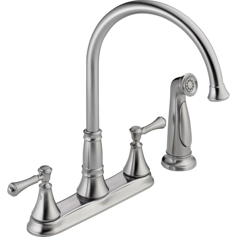 Stainless steel two-handle kitchen faucet with curved spout, detachable spray head, and lever handles.