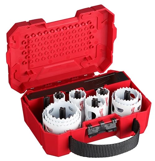 Red plastic case containing white and black bi-metal hole saws of various sizes with metal arbor tool.