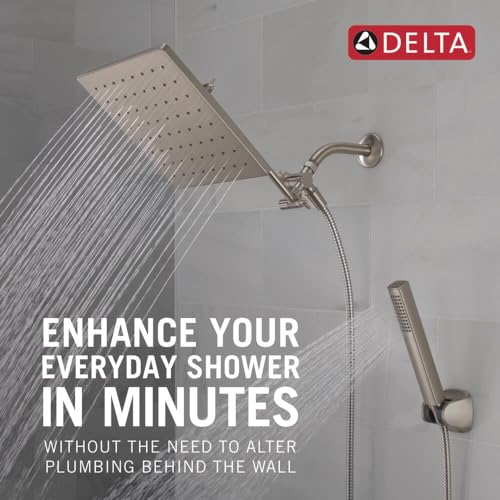 Brushed nickel raincan shower head with handheld wand and adjustable extension arm mounted on shower wall.
