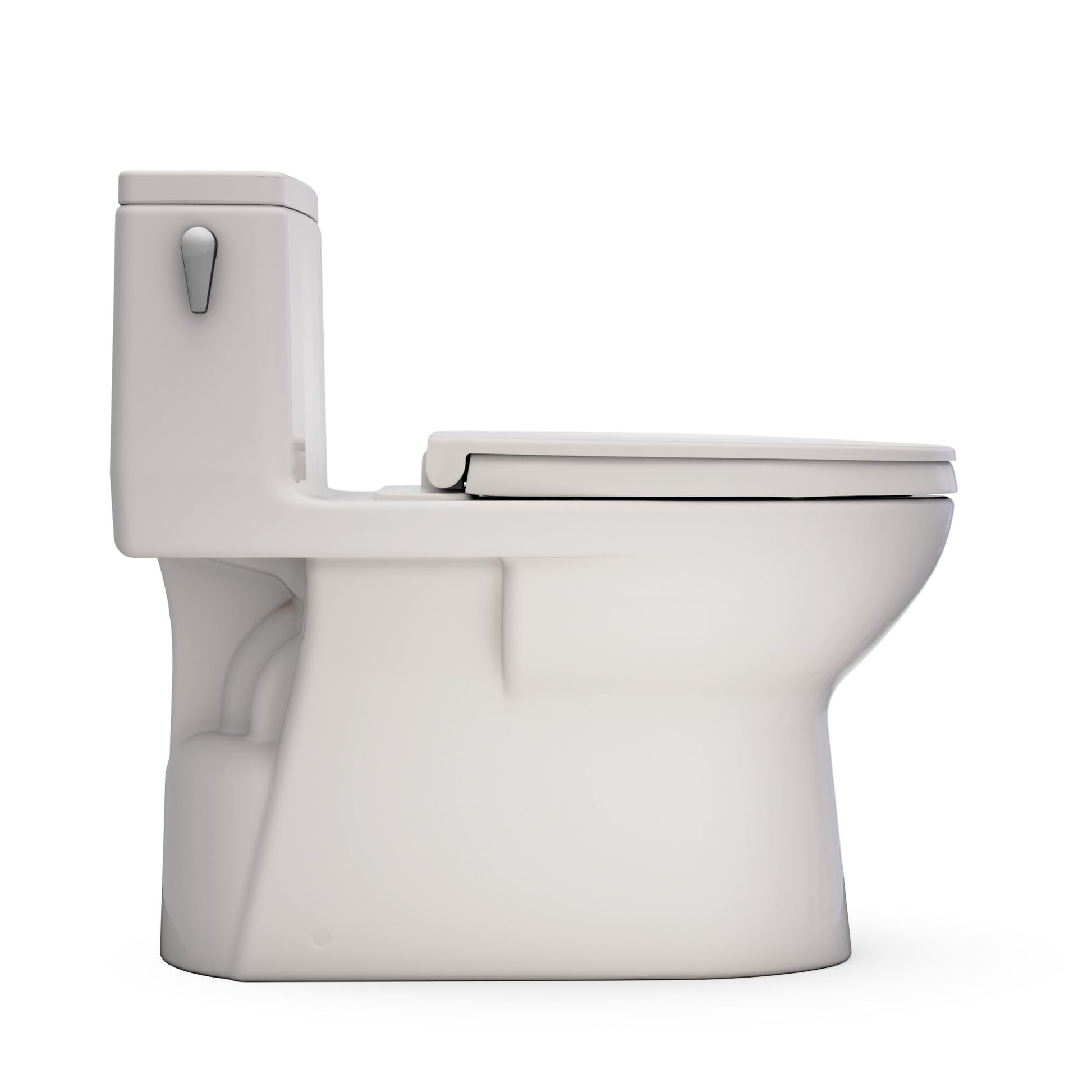 Sedona beige one-piece elongated toilet with integrated tank and closed lid in lowered position.