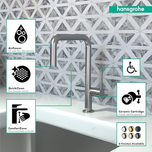 Brushed black chrome U-shaped kitchen faucet with high arc spout on white sink against patterned tile backsplash.