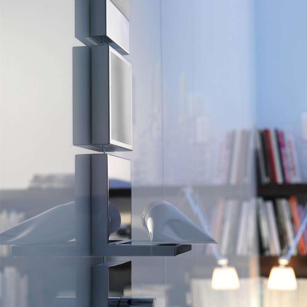 Chrome shower shelf with square shape mounted on vertical rail system against bathroom wall.