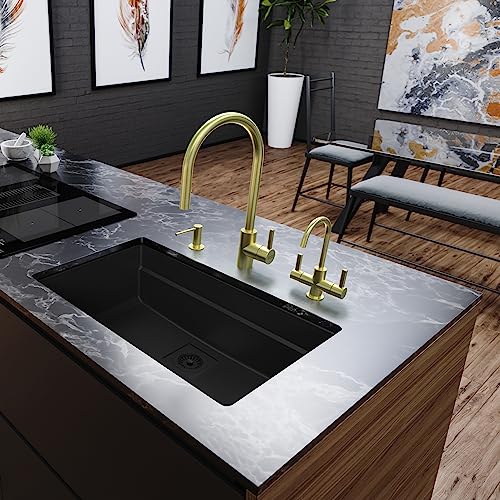 Gold single-handle pull-down kitchen faucet with matching side sprayers mounted on white marble countertop with black sink.
