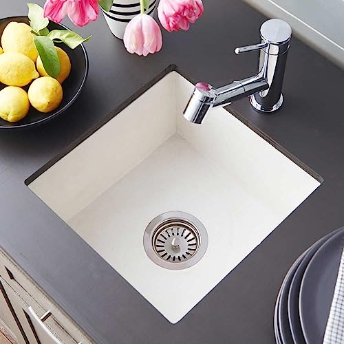 Ash-colored square undermount bar sink with chrome faucet and drain strainer installed in gray countertop.