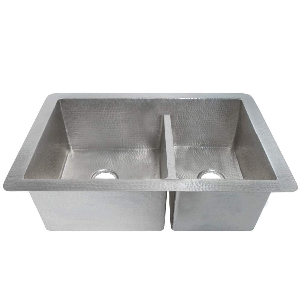 Brushed nickel dual-basin drop-in kitchen sink with hammered texture and drain holes.