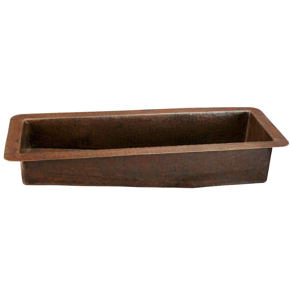 Hammered copper rectangular bar sink with sloped sides and dark patina finish.