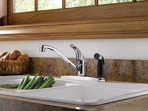 Chrome single-handle kitchen faucet with curved spout installed above white sink with granite countertop.