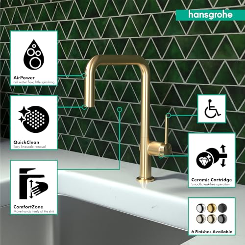 Hansgrohe Talis N brushed gold kitchen faucet with U-shaped spout on white sink against tiled backsplash.