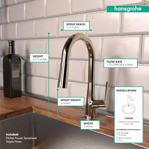 Polished nickel pull-down kitchen faucet with curved spout and spray head mounted on white subway tile backsplash.