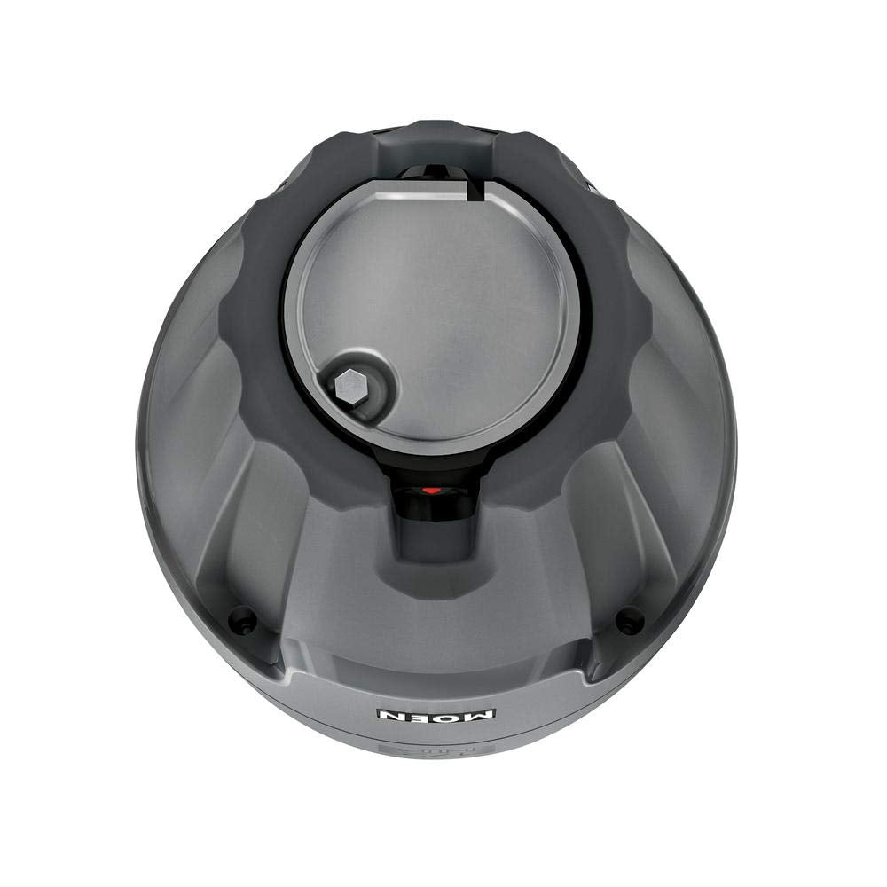 Gray and black Moen garbage disposal unit viewed from above, showing circular housing with central drain opening and control 