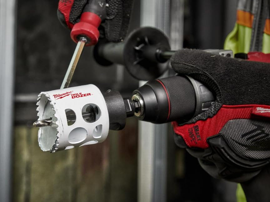Milwaukee HOLE DOZER bi-metal hole saw with white body and serrated cutting edges mounted in drill chuck.