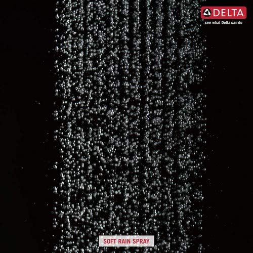Polished nickel raincan shower head with soft rain spray pattern against black background.