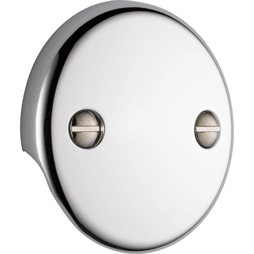 Chrome overflow plate with two holes and recessed oval screw covers, mounted on white background.