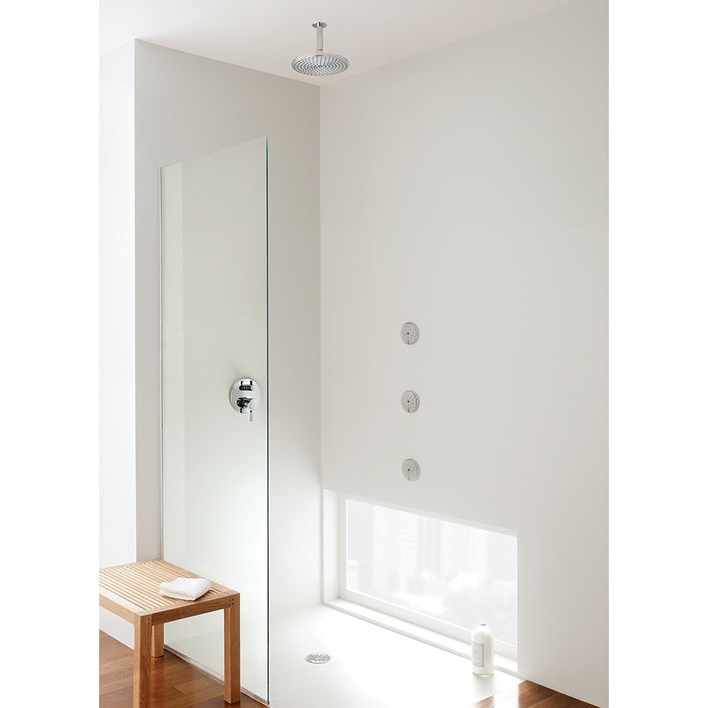 Brushed nickel round ceiling-mounted showerhead with overhead spray mounted above modern shower enclosure.