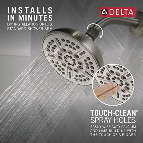 Satin nickel shower head with multiple spray holes and adjustable settings mounted on shower arm.