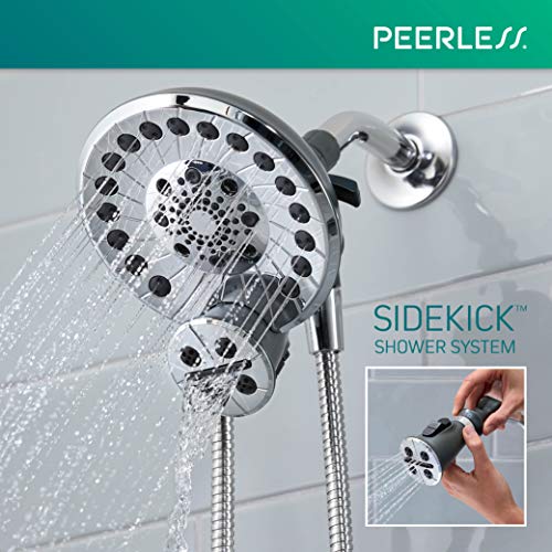 Chrome shower head with multiple spray holes and attached handheld showerhead on flexible hose against tiled wall.