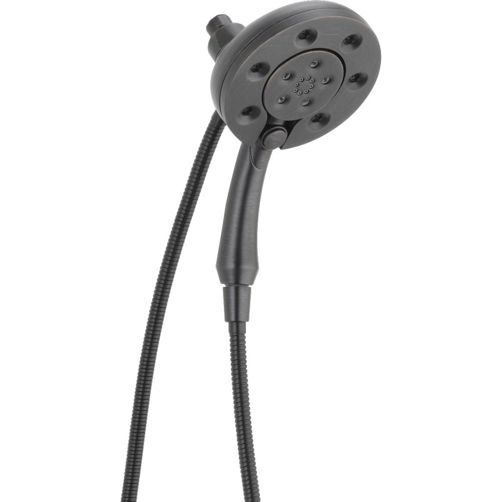 Chrome two-in-one shower head with circular face, multiple jets, handle grip, and attached hose.