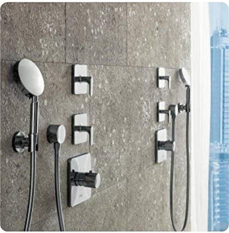 Chrome volume control trim with multiple outlet valves and handheld showerhead mounted on gray tile wall.