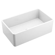 White fireclay single bowl undermount kitchen sink with curved apron front and rounded corners.