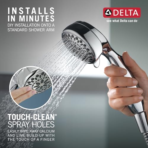 Chrome hand shower with multiple spray holes, held in hand demonstrating water stream.